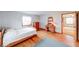 Bedroom features hardwood floors, natural light, and vintage-style dresser and mirror at 2215 W State Rd, Pendleton, IN 46064