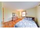 Bright bedroom features hardwood floors, complemented by a wooden dresser and a comfortable bed at 2215 W State Rd, Pendleton, IN 46064