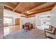 Open floor plan with wood ceilings, a dining area, and glimpses of both the kitchen and living room at 2215 W State Rd, Pendleton, IN 46064