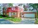 Charming two-story brick home featuring an attached garage and a well-maintained front yard with mature trees at 2215 W State Rd, Pendleton, IN 46064