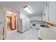 Bright kitchen features white cabinets, appliances, and countertops and a marble-patterned floor at 2215 W State Rd, Pendleton, IN 46064