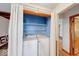 Efficient laundry area showcases a washer and dryer unit with ample shelving and storage space at 2215 W State Rd, Pendleton, IN 46064