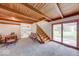 Cozy living room with wood-beamed ceilings and convenient access to the kitchen and outdoor patio at 2215 W State Rd, Pendleton, IN 46064