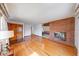 Spacious living room with gleaming hardwood floors and a charming fireplace at 2215 W State Rd, Pendleton, IN 46064