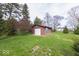 Charming outbuilding with a garage door and window, nestled in a well-kept yard at 2215 W State Rd, Pendleton, IN 46064