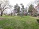 Spacious yard with mature trees, a home, and several outbuildings at 2215 W State Rd, Pendleton, IN 46064