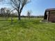 Expansive green backyard with fencing and mature trees, offering ample space at 2227 S County Road 300 E, Danville, IN 46122