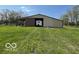 View of a spacious barn with a large sliding door open to the green field at 2227 S County Road 300 E, Danville, IN 46122