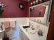 Traditional bathroom with vanity, mirror, and wall decorations at 2227 S County Road 300 E, Danville, IN 46122