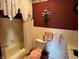 A full bath featuring a tub with shower, toilet, and floral wallpaper accents at 2227 S County Road 300 E, Danville, IN 46122