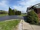 Wide asphalt driveway lined with mature evergreen trees and manicured bushes at 2227 S County Road 300 E, Danville, IN 46122