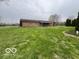 Brick home with sprawling green lawn, mature trees, and covered patio at 2227 S County Road 300 E, Danville, IN 46122