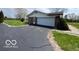 A single-story home featuring a brick exterior and a spacious asphalt driveway and two-car garage at 2227 S County Road 300 E, Danville, IN 46122