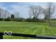 Extensive green field with mature trees and a fence in the background at 2227 S County Road 300 E, Danville, IN 46122