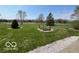 Well-maintained front yard with mature trees and lush green grass, enhancing curb appeal at 2227 S County Road 300 E, Danville, IN 46122