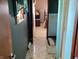 Hallway leads to a bedroom and bathroom with vintage flooring at 2227 S County Road 300 E, Danville, IN 46122