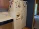 Traditional kitchen boasts wood cabinets, white refrigerator, and linoleum countertop at 2227 S County Road 300 E, Danville, IN 46122