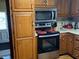 Functional kitchen featuring modern stainless steel appliances, oak cabinets, and ample counter space at 2227 S County Road 300 E, Danville, IN 46122