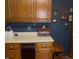 Functional kitchen with dark blue walls, oak cabinets, and ample counter space at 2227 S County Road 300 E, Danville, IN 46122