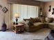 Comfortable living room features neutral carpet, an overstuffed sofa, and natural light at 2227 S County Road 300 E, Danville, IN 46122