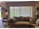Cozy living room features neutral carpet, a soft sofa, and a bright window at 2227 S County Road 300 E, Danville, IN 46122