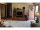 Cozy living room featuring an entertainment center and a pink front door at 2227 S County Road 300 E, Danville, IN 46122