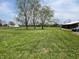 Expansive green lawn with mature trees and fenced boundaries, perfect for outdoor activities at 2227 S County Road 300 E, Danville, IN 46122