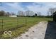 Expansive yard with well-maintained grass, mature trees, and a gated entrance in a peaceful setting at 2227 S County Road 300 E, Danville, IN 46122