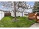 View of the backyard with grass, a detached garage and mature trees at 2615 N Delaware St, Indianapolis, IN 46205