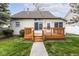 Cozy home featuring a wood deck and a well-maintained lawn at 2615 N Delaware St, Indianapolis, IN 46205