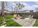 Landscaped backyard with fire pit and stone patio and seating area at 2615 N Delaware St, Indianapolis, IN 46205