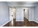 A bedroom with hardwood floors, blue walls, and two entrances to closets at 2615 N Delaware St, Indianapolis, IN 46205