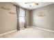 This is a carpeted bedroom with a cute decoration, a window, and shelves on the wall at 2615 N Delaware St, Indianapolis, IN 46205