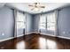 This is a beautiful bedroom with two large windows, hardwood floors, and a ceiling fan at 2615 N Delaware St, Indianapolis, IN 46205