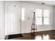 Bright entryway featuring a white front door, wood floors, and a large window at 2615 N Delaware St, Indianapolis, IN 46205