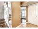 Welcoming entryway featuring hardwood floors, a staircase, and an open doorway to the living room at 2615 N Delaware St, Indianapolis, IN 46205