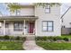Inviting two-story home featuring a cozy front porch with decorative plants and walkway at 2615 N Delaware St, Indianapolis, IN 46205