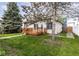 View of a home with a wood deck, grass and mature trees at 2615 N Delaware St, Indianapolis, IN 46205