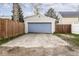 Detached two-car garage with blue doors and a concrete driveway at 2615 N Delaware St, Indianapolis, IN 46205