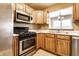 The kitchen features stainless steel appliances, a gas range, and natural wood cabinetry at 2615 N Delaware St, Indianapolis, IN 46205