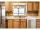 Updated kitchen with stainless appliances, light wood cabinets, and a view to the dining area at 2615 N Delaware St, Indianapolis, IN 46205
