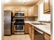 This kitchen features a gas range, stainless steel appliances, and light wood cabinets at 2615 N Delaware St, Indianapolis, IN 46205