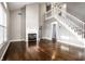 Spacious living room with hardwood floors, fireplace, and stairs to the upper level at 2615 N Delaware St, Indianapolis, IN 46205