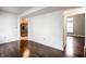 Spacious living area with hardwood floors, opening to a kitchen and additional rooms at 2615 N Delaware St, Indianapolis, IN 46205