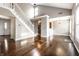 Open-concept living area with hardwood floors, a staircase, and ample natural light at 2615 N Delaware St, Indianapolis, IN 46205