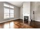 Bright living room with hardwood floors, fireplace, and large window with natural light at 2615 N Delaware St, Indianapolis, IN 46205