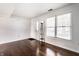 Bright living room with a front door, large window, and hardwood floors at 2615 N Delaware St, Indianapolis, IN 46205