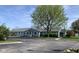 Charming single-story home featuring light blue siding, white trim, and a well-maintained lawn, beneath a bright sky at 2715 Prosperity Dr, Columbus, IN 47201