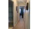 Hallway leads to a bedroom with plush carpet, and neutral walls with decorative accents at 2715 Prosperity Dr, Columbus, IN 47201