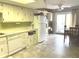 Spacious kitchen features tile flooring, white appliances, ample counter space and backyard access at 2715 Prosperity Dr, Columbus, IN 47201